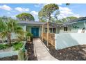 Inviting front entrance with double doors, decorative plants, and a covered walkway with string lights at 14199 82Nd Avenue, Seminole, FL 33776