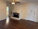 Cozy living room with hardwood floors and a painted brick fireplace that creates a warm, inviting space at 1902 W Aileen St, Tampa, FL 33607