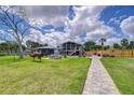 Expansive backyard features a well-manicured lawn, patio area, perfect for entertaining guests at 202 7Th Sw St, Ruskin, FL 33570