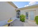 Charming side patio area with a table and chairs, leading to the home's entry and second door at 2220 Nantucket Dr # 43, Sun City Center, FL 33573