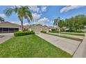 Inviting single-story home with manicured lawn and driveway leading to a two-car garage at 2220 Nantucket Dr # 43, Sun City Center, FL 33573
