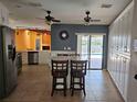 Bright kitchen with island, stainless steel appliances, and access to pool area at 2704 E Montague E Ct, Clearwater, FL 33761