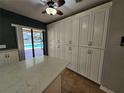 Kitchen features ample storage with white cabinets and backyard view at 2704 E Montague E Ct, Clearwater, FL 33761