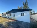 Side view of charming single-story home with a fresh white exterior at 342 51St N Ave, St Petersburg, FL 33703
