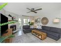 Bright living room featuring modern furnishings, fireplace, and access to outdoor balcony at 375 Madeira Cir, St Petersburg, FL 33715