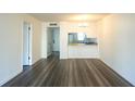 Open living room layout featuring wood-look flooring and kitchen view at 3803 N Oak Dr # B21, Tampa, FL 33611