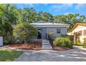The house is accented with mature trees adding shade and enhanced curb appeal to the property at 403 Saint Petersburg W Dr, Oldsmar, FL 34677
