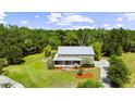 Picturesque aerial view showcasing this secluded two-story home surrounded by lush greenery and mature trees at 4702 Cypress Serenity Dr, Plant City, FL 33565
