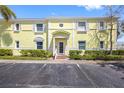 Charming yellow condo building with classic architectural details, well-maintained landscaping, and ample parking at 4740 Beach Se Dr # A, St Petersburg, FL 33705