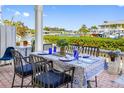 Charming outdoor patio with waterfront views, dining table, blue accents and lush foliage at 4740 Beach Se Dr # A, St Petersburg, FL 33705
