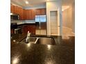 Gourmet kitchen featuring stainless appliances, granite counters, walk-in pantry, and a double basin sink at 5221 Bannister Park Ln, Lithia, FL 33547