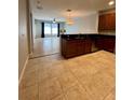 Open kitchen with tile floor, granite countertops, stainless steel appliances and a sink at 5221 Bannister Park Ln, Lithia, FL 33547