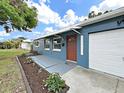 Home featuring a charming blue exterior, with a white awning over the entryway at 5772 4Th N Ave, St Petersburg, FL 33710