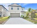 Beautiful two-story home with a two-car garage, long driveway, and meticulously maintained front lawn with landscaping at 582 Royal Empress Dr, Ruskin, FL 33570