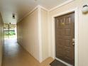 View of a brown front door in a hallway with the letter 