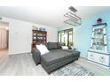 Living room with a gray sectional sofa and light blue accent wall at 6006 Laketree Ln # K, Temple Terrace, FL 33617