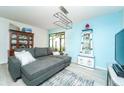 Cozy living room with a large gray sofa, decorative furnishings, and lots of natural light at 6006 Laketree Ln # K, Temple Terrace, FL 33617