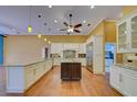 Spacious kitchen featuring custom white cabinetry, large island, and stainless steel appliances at 7333 Royal Oak Dr, Spring Hill, FL 34607