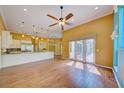 Open-concept living room features hardwood floors, high ceilings, and access to outdoor space at 7333 Royal Oak Dr, Spring Hill, FL 34607