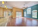 Open-concept living room features hardwood floors, high ceilings, and large windows at 7333 Royal Oak Dr, Spring Hill, FL 34607