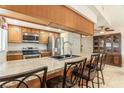This kitchen features a breakfast bar, stainless steel appliances, and ample counter space for cooking prep at 7426 Cay Dr, Port Richey, FL 34668