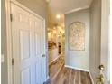 View of the light and bright entryway with a decorative wall inset and wood-look flooring at 11246 Kapok Grand Cir, Madeira Beach, FL 33708