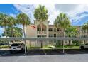 Condominium building showing assigned covered parking and tropical landscaping on the property at 11720 Park Blvd # 301, Seminole, FL 33772