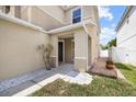 Inviting front entrance with a covered porch, manicured lawn, and decorative stone accents at 12107 Fox Bloom Ave, Gibsonton, FL 33534