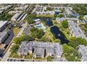 Aerial view of a condominium community with scenic waterways, lush landscaping and a pool at 14130 Rosemary Ln # 1202, Largo, FL 33774