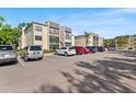 Exterior view of condominium complex with ample parking on a sunny day at 14130 Rosemary Ln # 1202, Largo, FL 33774