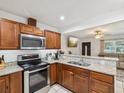 Modern kitchen with wooden cabinets, stainless steel appliances, and open design at 232 Emerald Ln, Largo, FL 33771