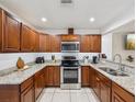 Well-equipped kitchen featuring stainless steel appliances and granite countertops at 232 Emerald Ln, Largo, FL 33771