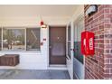 Close up shot of the front door with a screen door and a fire extinguisher box to the right at 2366 Shelley St # 7, Clearwater, FL 33765