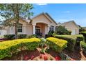 Well-maintained one-story home featuring a blue front door and colorful landscaping at 2515 Centennial Falcon Dr, Valrico, FL 33596