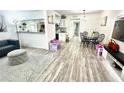 Bright living room boasts wood-look floors, neutral tones, modern furnishings, and an open-concept design at 2525 W Bay Dr # A20, Belleair Bluffs, FL 33770
