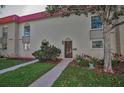 Exterior view of two-story townhomes with sidewalks and lush landscaping at 2700 Bayshore Blvd # 547, Dunedin, FL 34698