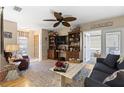 Cozy living room with hardwood floors, comfortable seating, ceiling fan and access to enclosed porch at 2735 Sherbrooke Ln # D, Palm Harbor, FL 34684