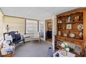 Bright sunroom with a variety of seating options, natural light, and vintage furniture at 2735 Sherbrooke Ln # D, Palm Harbor, FL 34684
