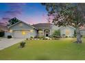 Charming single-story home with well-maintained landscaping and inviting curb appeal on a cloudy day at 3004 Spring Hammock Dr, Plant City, FL 33566