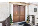 Elegant arched double doors, festive decorations, and stone façade enhances curb appeal at 3087 Cherry Ln, Clearwater, FL 33759