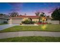 Charming single-story home featuring a red roof, well-maintained landscaping, and an attached two-car garage at 3092 Hillside Ln, Safety Harbor, FL 34695