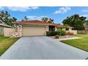 Charming home with an attached two-car garage and landscaped front yard at 3092 Hillside Ln, Safety Harbor, FL 34695