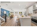 Open-concept kitchen and living area, featuring white cabinetry and a modern island at 3505 N Dartmouth Ave, Tampa, FL 33603