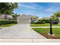 Inviting single-Gathering home with a well-manicured lawn and a paved driveway at 3726 Rain Tree Ct, Palm Harbor, FL 34685