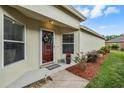 Welcoming front entryway with a decorative wreath and manicured landscaping at 5116 Gato Del Sol Cir, Wesley Chapel, FL 33544