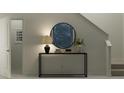 Elegant entryway featuring a console table, decorative mirror, and a staircase at 5607 Red Kite Dr, Wimauma, FL 33598