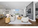 Spacious living area with hardwood floors, modern fireplace, open floor plan, and stylish furnishings at 804 S Davis Blvd, Tampa, FL 33606