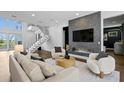 Bright living room featuring a modern fireplace, statement wall, and an open staircase at 804 S Davis Blvd, Tampa, FL 33606