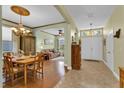 Spacious living area with hardwood floors, fresh wall paint, and elegant chandelier lighting at 8202 Pinewood Run Ct, Tampa, FL 33647