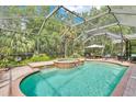Inviting screened-in pool area with a connected hot tub and ample seating for outdoor relaxation and entertainment at 8202 Pinewood Run Ct, Tampa, FL 33647